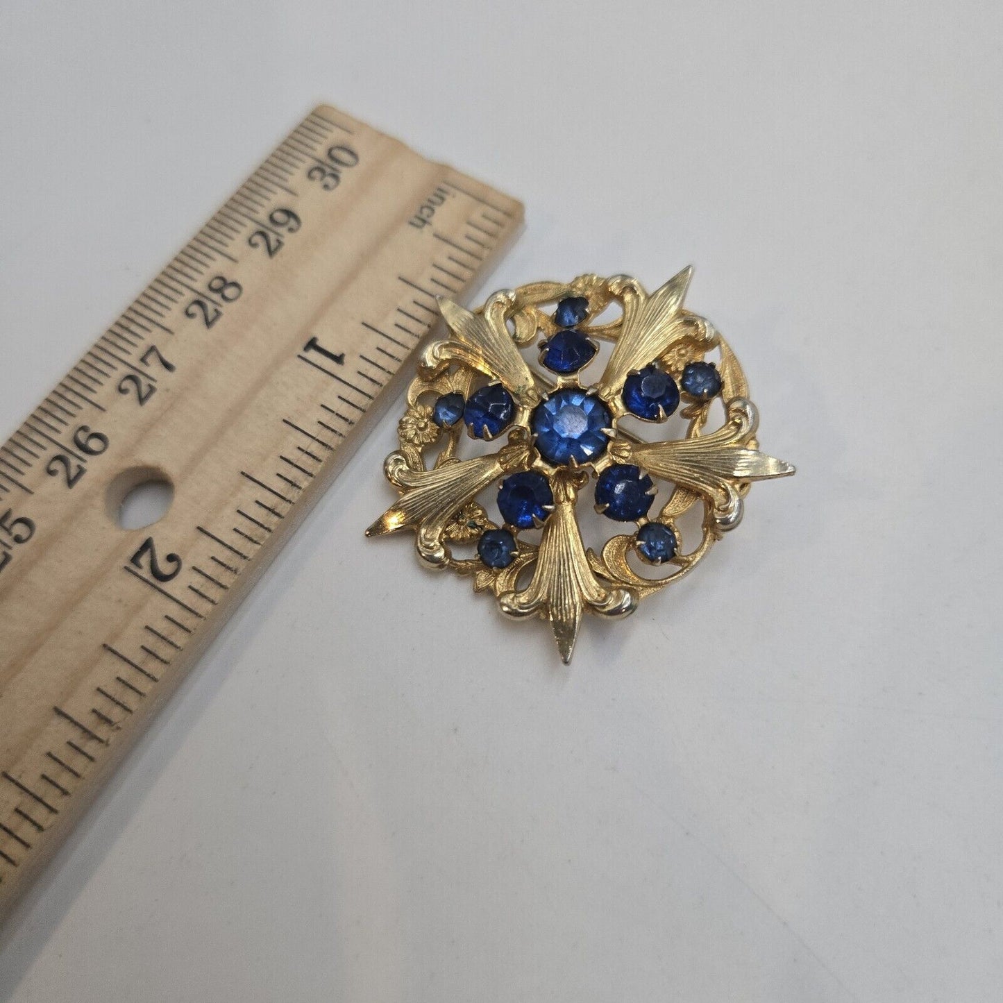 Vintage Blue Prong Set Rhinestone Gold Tone Fleur De Lis Round Brooch