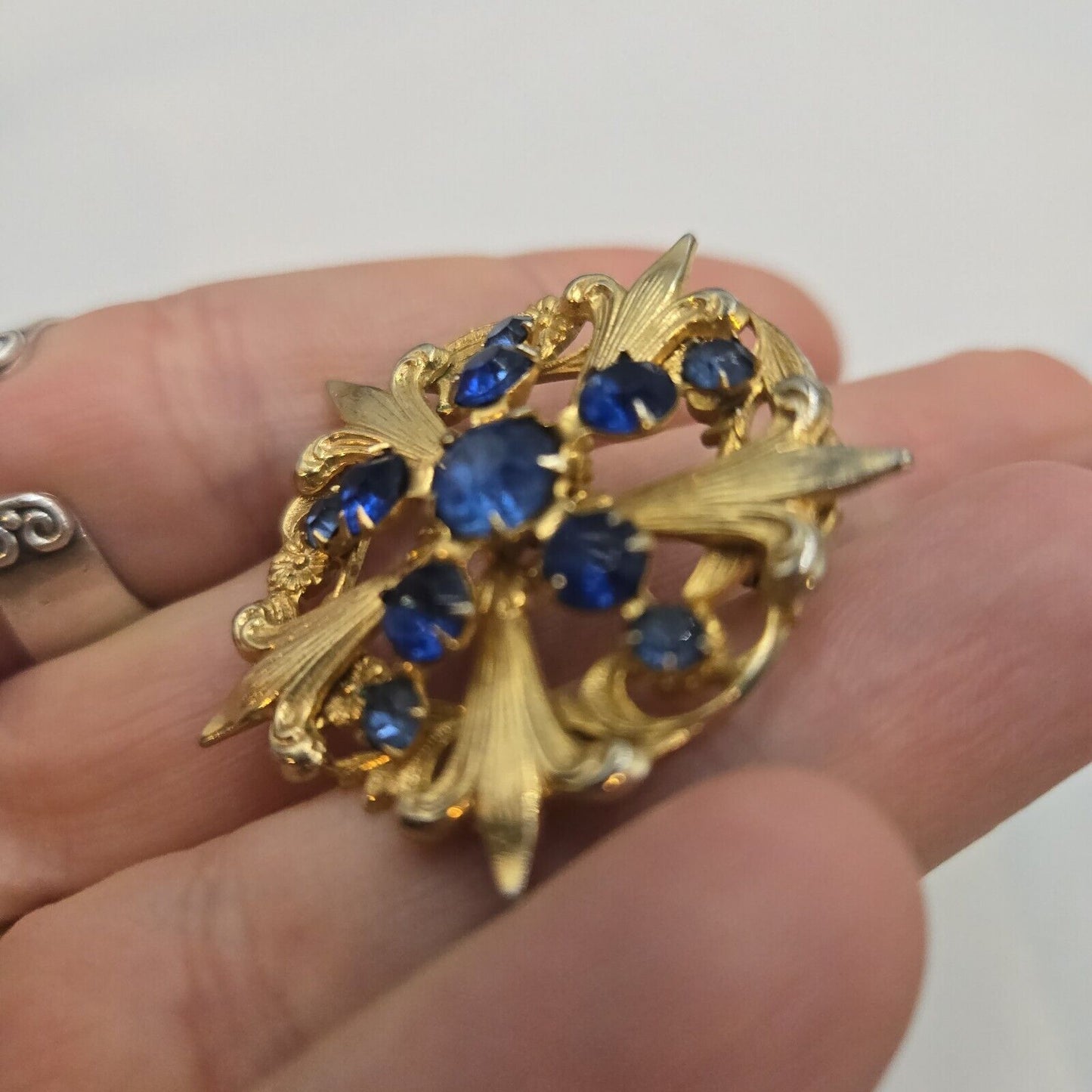 Vintage Blue Prong Set Rhinestone Gold Tone Fleur De Lis Round Brooch